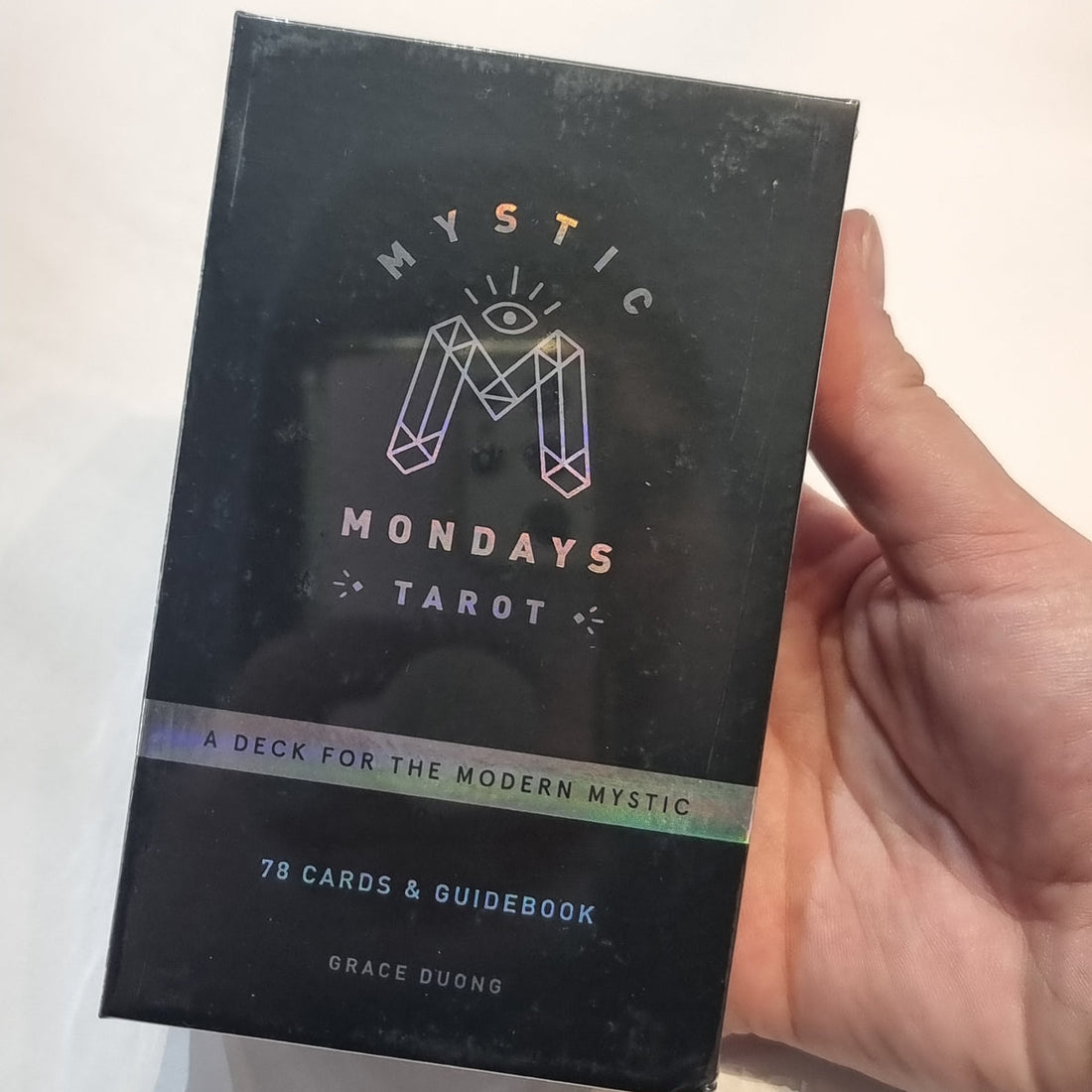 Colourful Mystic Mondays tarot deck box on a pale background