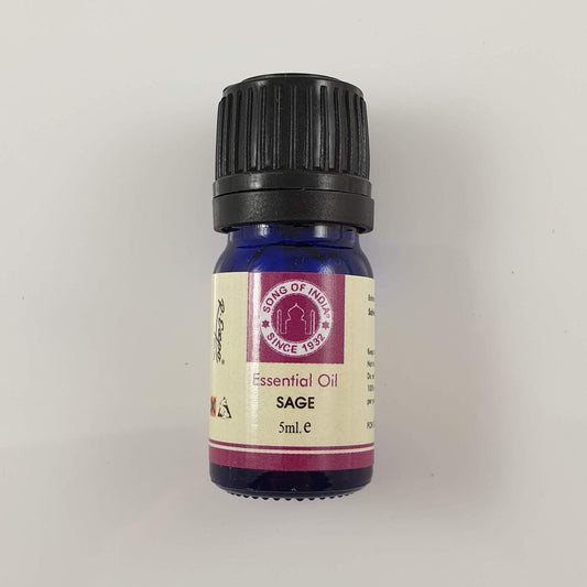 A cobalt-blue Song of India Sage essential oil bottle with a black cap and cream label on a pale grey surface