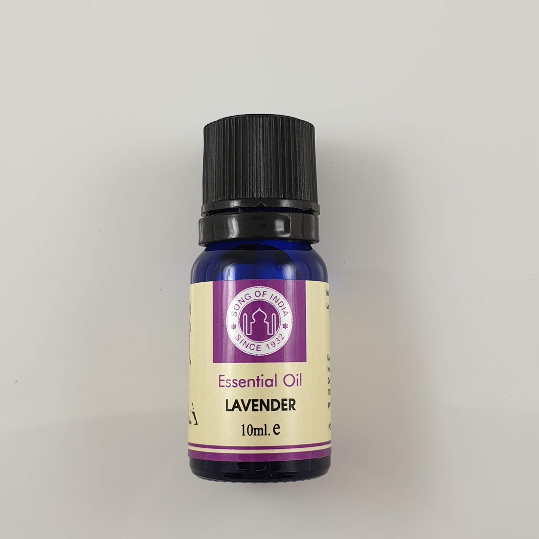 Blue glass 10 ml bottle of Song of India lavender essential oil with a black cap and purple-banded label on a white background
