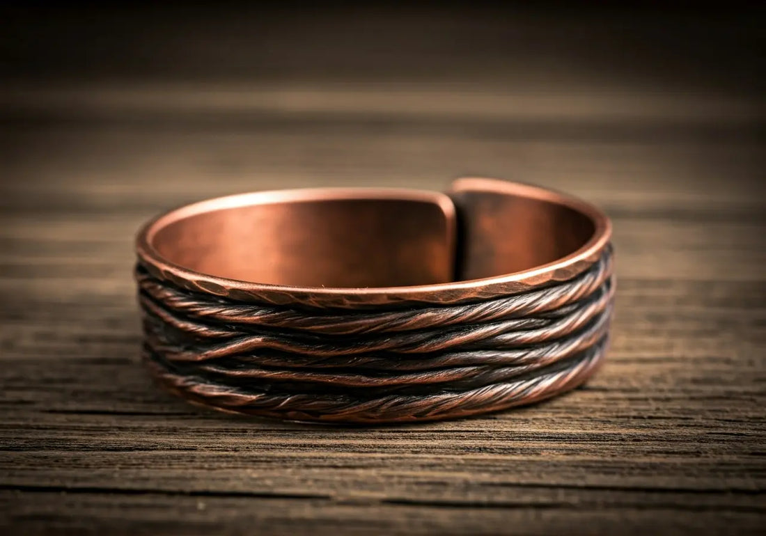 Close-up of a copper bracelet resting on a wooden table