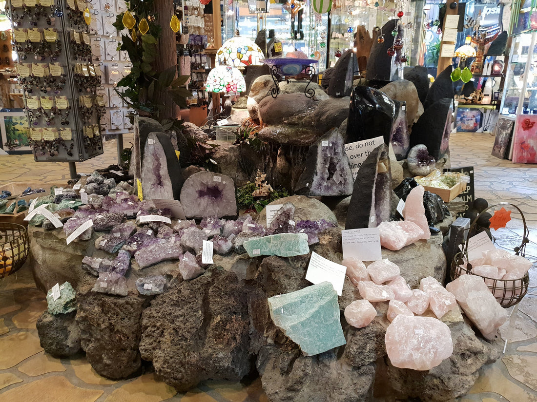 Amethyst clusters and pale pink rough crystals on display at Rivendell Shop
