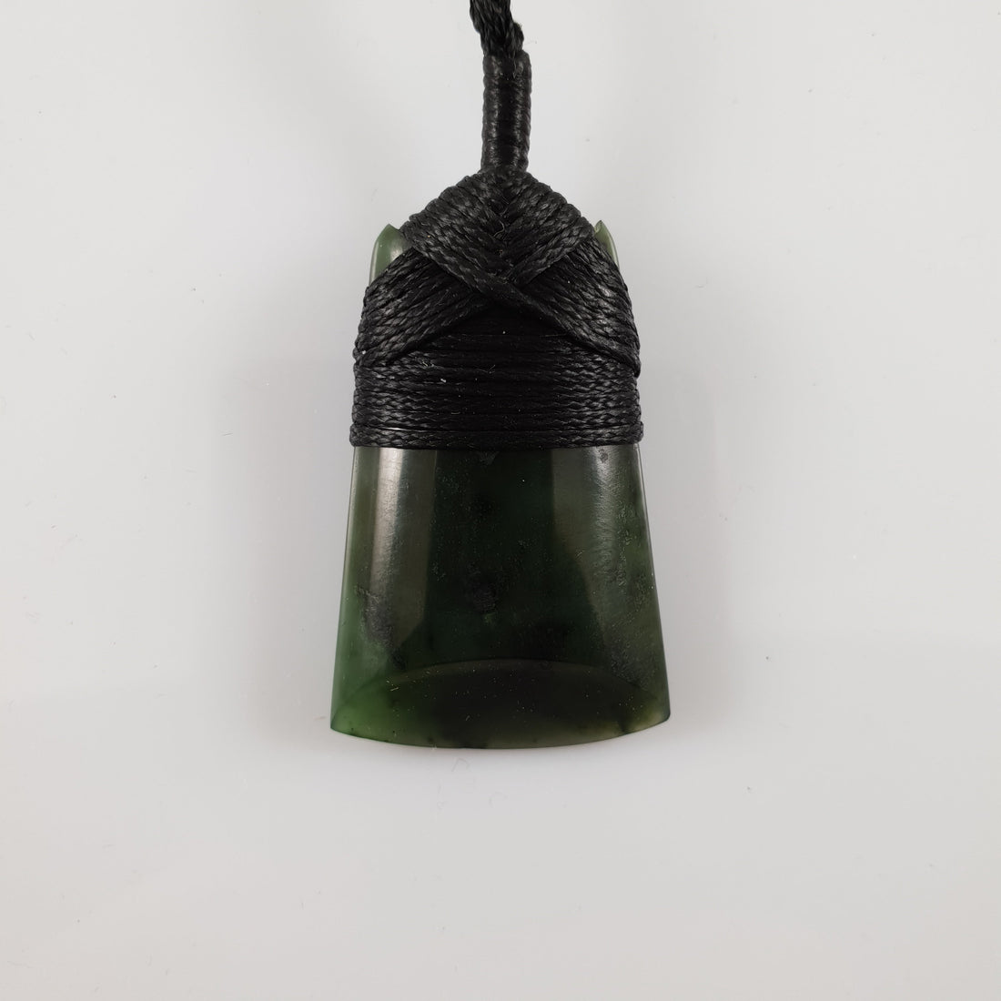Greenstone toki pendant with a bound cord and greenstone toggle