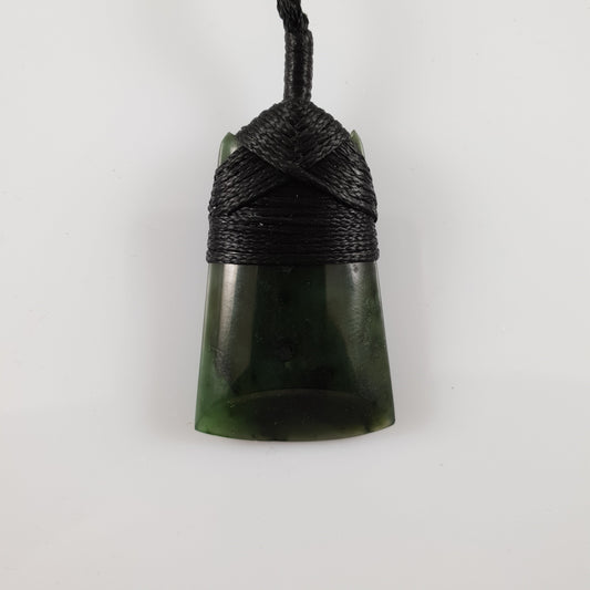 Greenstone toki pendant with a bound cord and greenstone toggle
