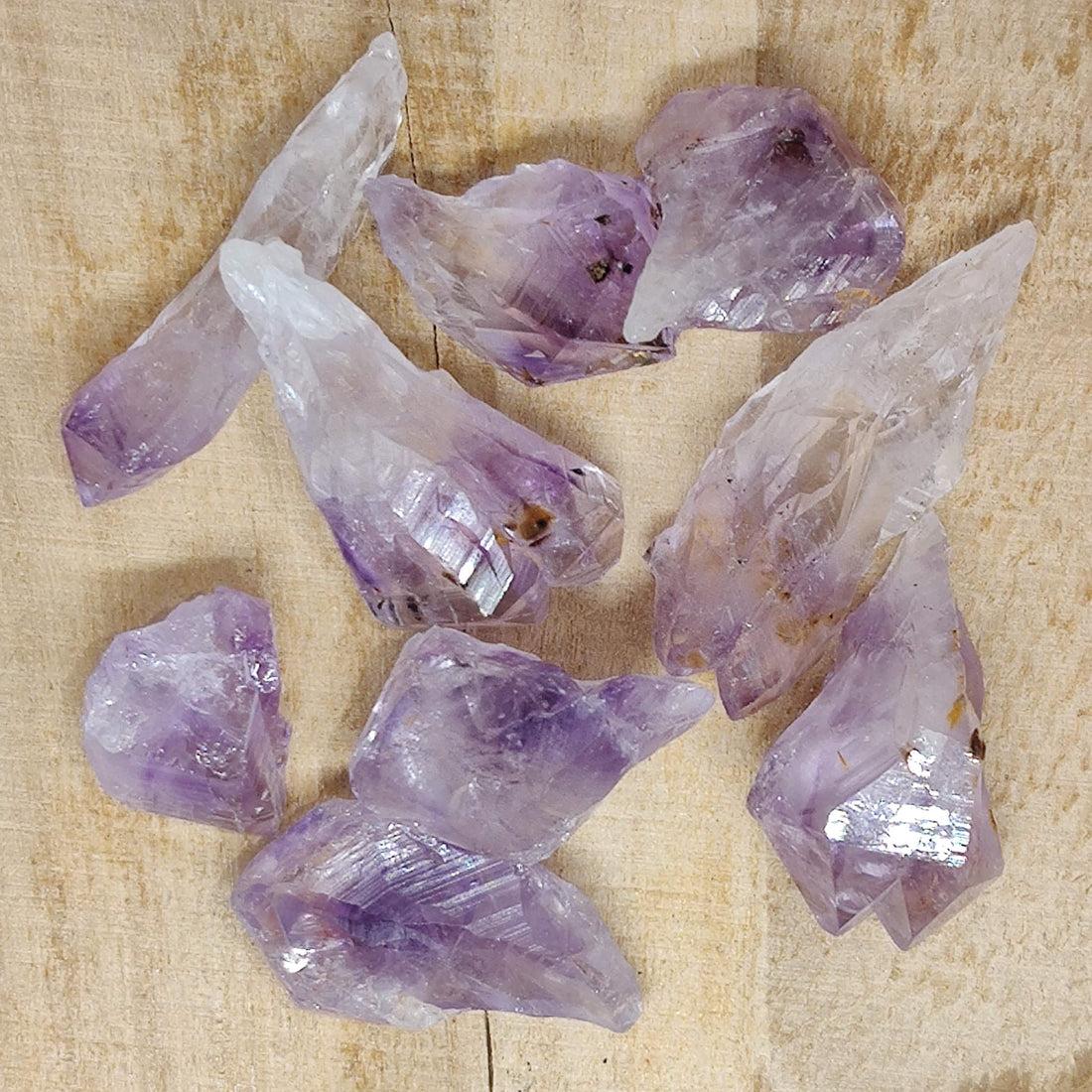 Natural amethyst pieces on a pale textured surface