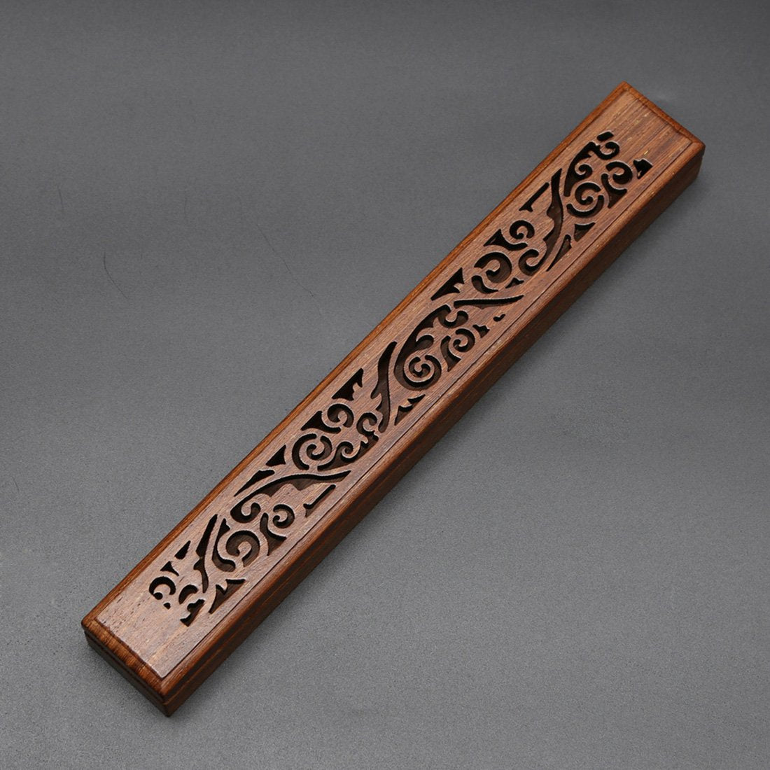 Wooden Koru incense box with a carved lid.