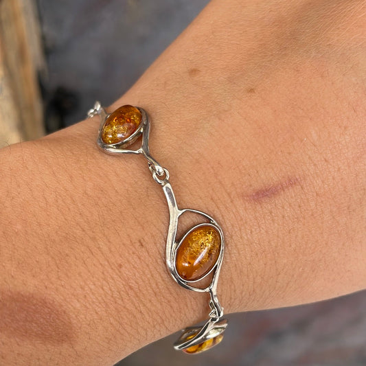 Sterling silver bracelet set with warm honey-coloured amber stones
