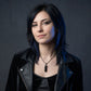 Young woman wearing a black obsidian point necklace in a goth-inspired studio portrait