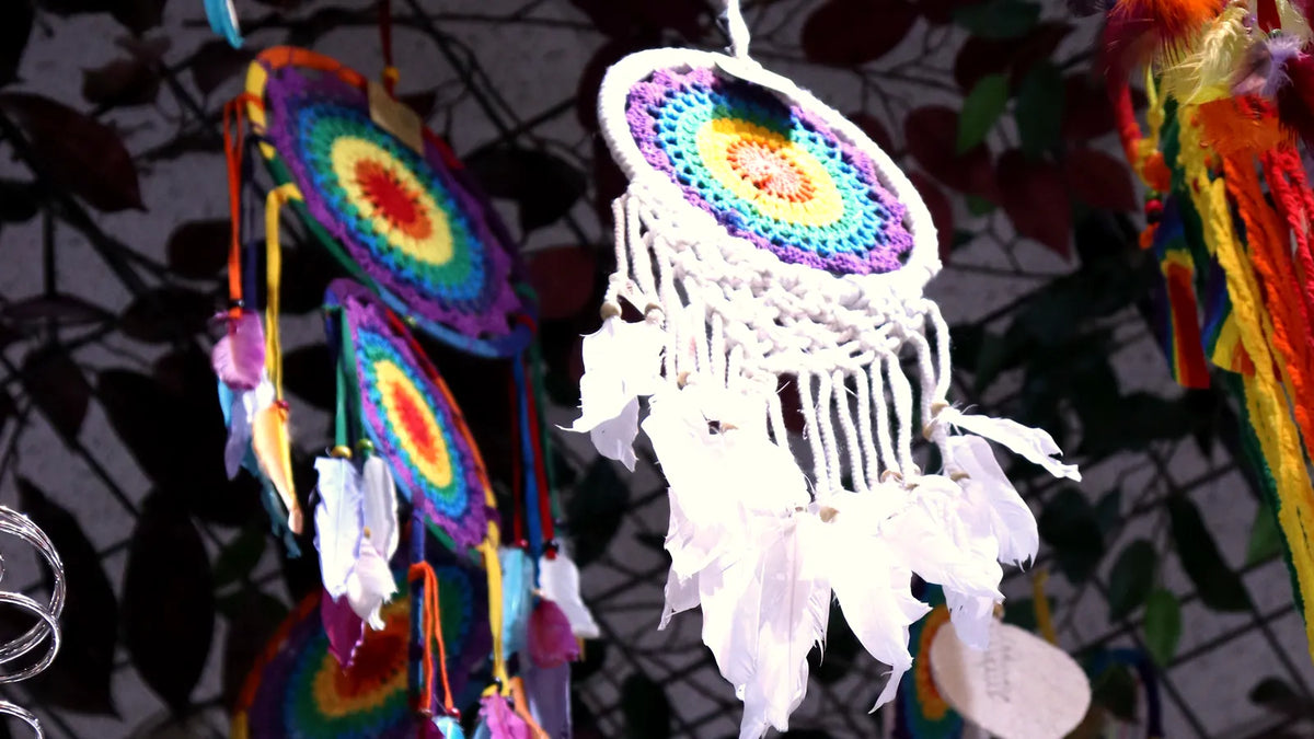 Rainbow and white dreamcatchers hanging from the shop ceiling