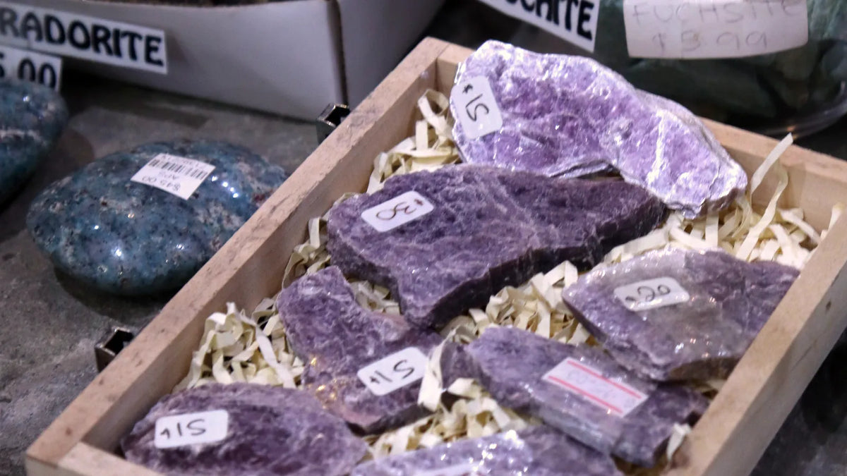 Trays of raw lepidolite and fuchsite with labels