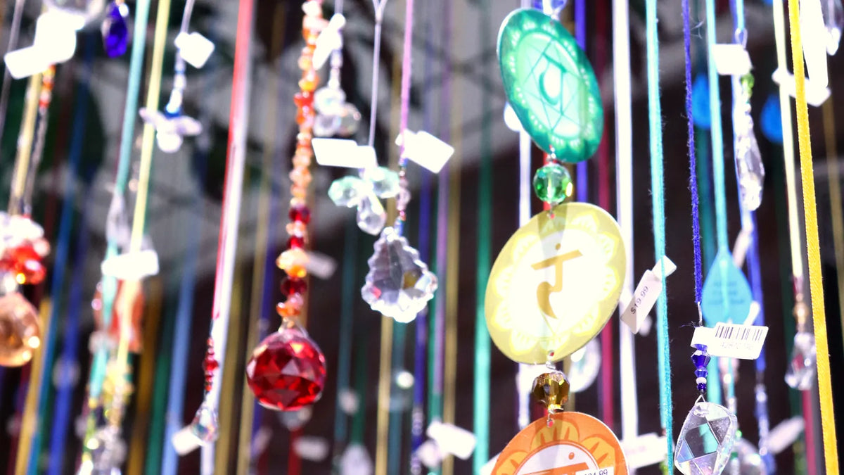 Crystal suncatchers and chakra charms hanging in the shop