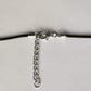 Lobster clasp and extender chain on the black waxed necklace cord